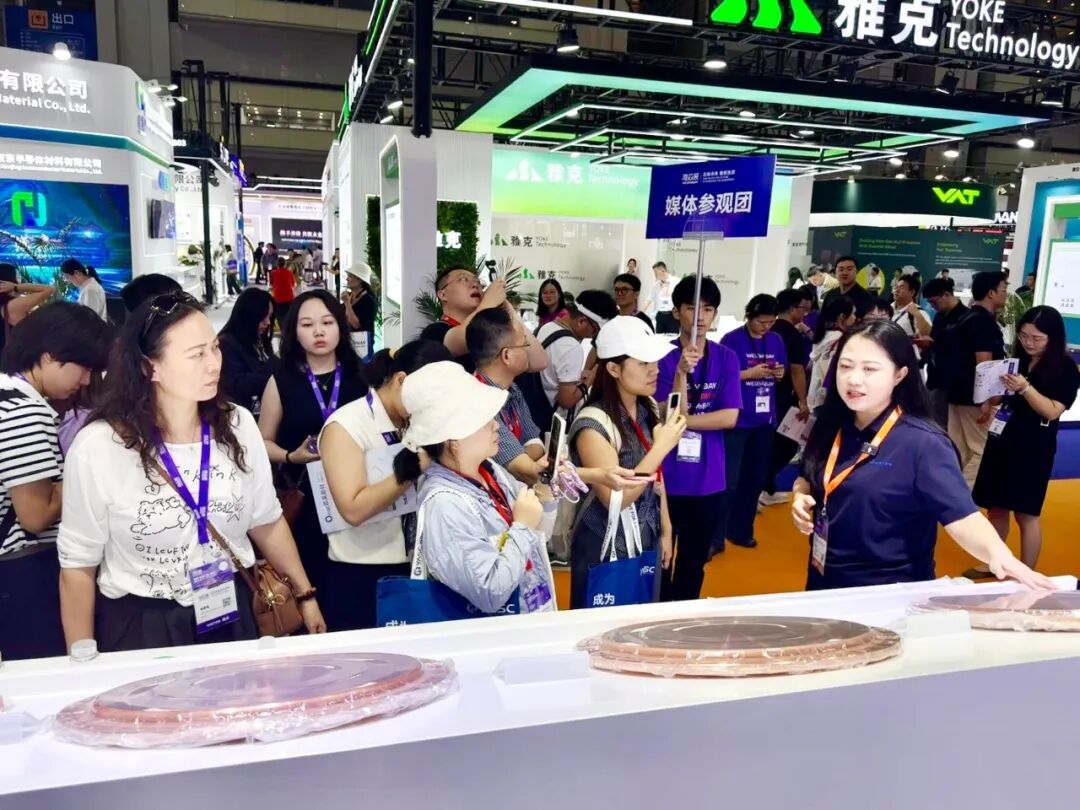 A media tour group visits the Omat booth